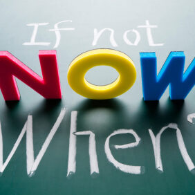 If not now, when? Colorful words on blackboard.